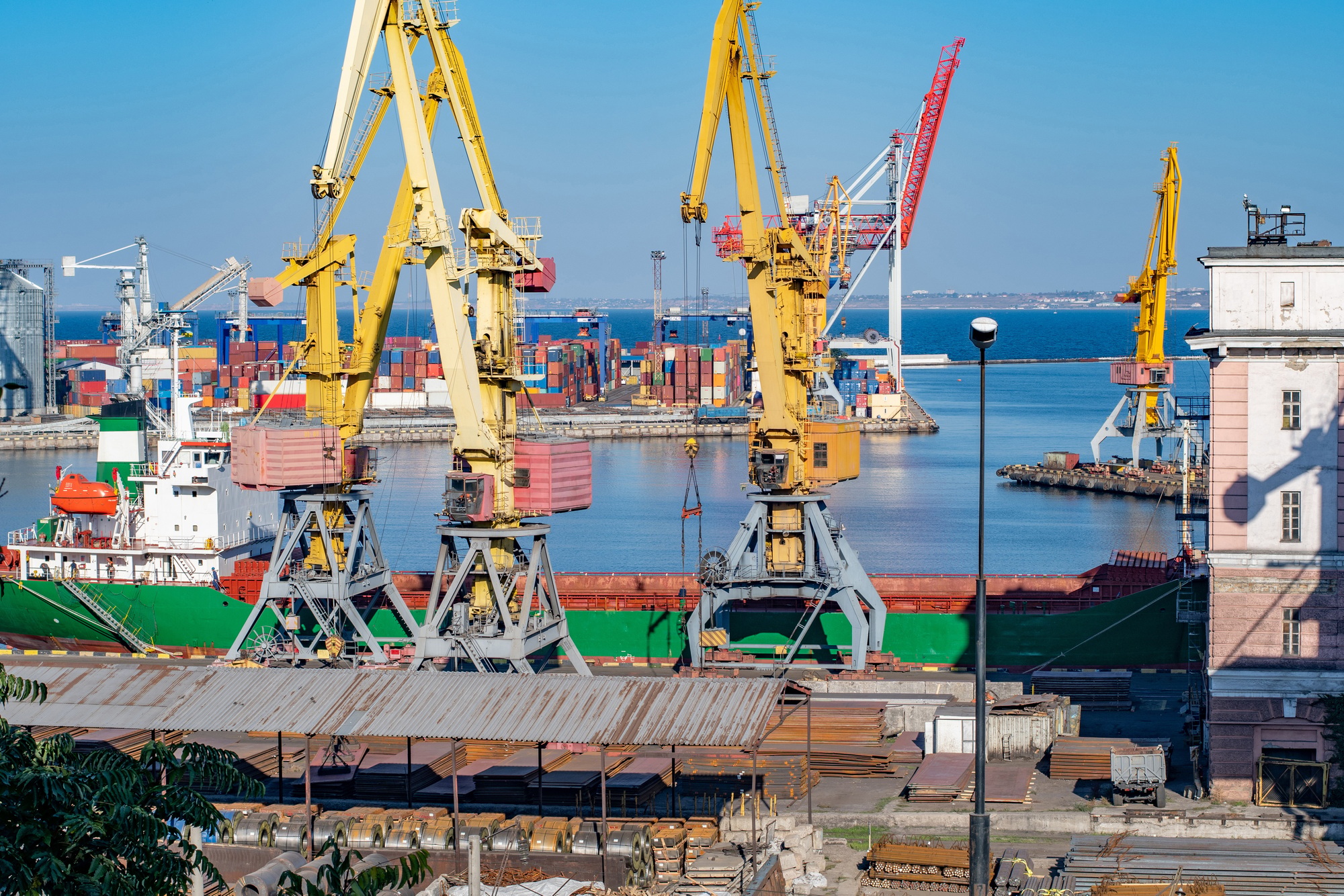 Industrial landscape of sea trading port with heavy loading machinery